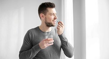 man taking medicine to treat prostatitis